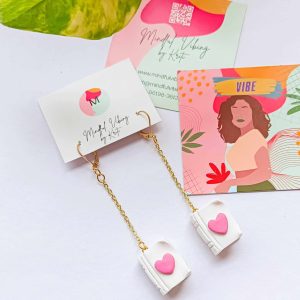 pride book polymer clay earrings by mindful vibing